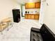 Bright living space with a kitchenette, black refrigerator, and dining table set at 467 Martigues Drive, Kissimmee, FL 34759