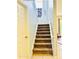 Carpeted staircase leading to the upper level of the home, with light-colored walls and white trim at 467 Martigues Drive, Kissimmee, FL 34759