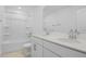 Bright bathroom featuring double sinks, quartz countertops, and tub with shower at 1027 Cloud Ridge Ct, Mount Dora, FL 32757