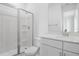 Modern bathroom with glass enclosed shower, white vanity, and quartz countertop at 1027 Cloud Ridge Ct, Mount Dora, FL 32757