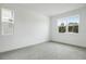 Empty bedroom featuring natural light, a large window, and neutral gray tile flooring at 1027 Cloud Ridge Ct, Mount Dora, FL 32757