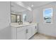 Bright bathroom with double vanity, sleek faucets, and a large mirror reflecting the contemporary design at 1035 Cloud Ridge Ct, Mount Dora, FL 32757