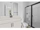 Modern bathroom featuring a sleek vanity with stone countertop and a glass-enclosed shower with black trim at 1035 Cloud Ridge Ct, Mount Dora, FL 32757