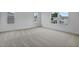 Spacious bedroom with neutral carpet and multiple windows, showcasing the ample natural light at 1035 Cloud Ridge Ct, Mount Dora, FL 32757
