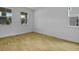 Bright, unfurnished bedroom with wood-look tile flooring and ample natural light from two windows at 1035 Cloud Ridge Ct, Mount Dora, FL 32757