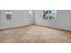 Unfurnished bedroom with wood-look tile flooring and natural light from large windows at 1035 Cloud Ridge Ct, Mount Dora, FL 32757