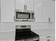 Close-up of a modern kitchen with stainless steel appliances and white subway tile backsplash at 1035 Cloud Ridge Ct, Mount Dora, FL 32757