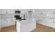 Modern kitchen featuring white cabinetry, quartz countertops, stainless steel appliances, and a center island at 1035 Cloud Ridge Ct, Mount Dora, FL 32757