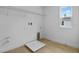 Functional laundry room with wooden flooring, storage rack and window for natural light at 1035 Cloud Ridge Ct, Mount Dora, FL 32757