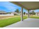 Covered patio overlooking a spacious yard and neighboring homes, perfect for outdoor enjoyment at 1035 Cloud Ridge Ct, Mount Dora, FL 32757