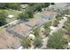 Aerial view of residential homes showing yards, street, and swimming pool enclosures at 1043 Tourmaline Dr, Kissimmee, FL 34746