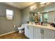Well-lit bathroom features a shower, a toilet, and a vanity with double sinks at 1043 Tourmaline Dr, Kissimmee, FL 34746