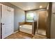 Bathroom features a tiled shower, a soaking tub, and a window for natural light at 1043 Tourmaline Dr, Kissimmee, FL 34746