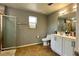 Well-lit bathroom features a shower, a toilet, and a vanity with double sinks at 1043 Tourmaline Dr, Kissimmee, FL 34746