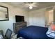 Bedroom with a ceiling fan, closet, dresser, mounted television, and plank flooring at 1043 Tourmaline Dr, Kissimmee, FL 34746