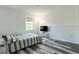 Neutral bedroom features wood-look floors, a large window, and a TV at 1043 Tourmaline Dr, Kissimmee, FL 34746