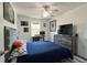 This bedroom boasts a ceiling fan, desk and chair, and dresser with a tv set upon it at 1043 Tourmaline Dr, Kissimmee, FL 34746