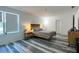 Bright bedroom features gray plank flooring, neutral decor, and a modern platform bed frame at 1043 Tourmaline Dr, Kissimmee, FL 34746