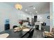 Dining area featuring modern lighting and a view into the kitchen and living spaces at 1043 Tourmaline Dr, Kissimmee, FL 34746