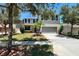 Charming home featuring a well-manicured lawn, a two-car garage, and mature trees offering shade and curb appeal at 1043 Tourmaline Dr, Kissimmee, FL 34746