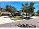 Street view of home showcasing well-maintained landscaping, lawn, and attached garages at 1043 Tourmaline Dr, Kissimmee, FL 34746