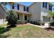 Well maintained front yard with green grass and mulch beds, a dark front door, and storm shutters at 1043 Tourmaline Dr, Kissimmee, FL 34746