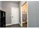 Hallway leading to a half bath featuring stylish tilework at 1043 Tourmaline Dr, Kissimmee, FL 34746