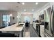 Bright kitchen with white cabinets, stainless appliances, breakfast bar and eat-in dining area at 1043 Tourmaline Dr, Kissimmee, FL 34746