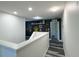Upstairs landing area featuring accent wall with decorations and gray wood-look flooring at 1043 Tourmaline Dr, Kissimmee, FL 34746