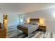 Main bedroom with walk-in closet, gray wood-look flooring, and stylish, modern furniture at 1043 Tourmaline Dr, Kissimmee, FL 34746