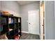 A mud room with gray walls, vinyl floors, and black shelf with easy access to bathroom at 1043 Tourmaline Dr, Kissimmee, FL 34746