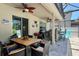 Covered outdoor dining area with ceiling fans, outdoor bar, grill, and view of the pool at 1043 Tourmaline Dr, Kissimmee, FL 34746