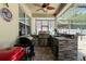 Outdoor kitchen boasts granite countertops, stainless steel grill, and a ceiling fan for comfort at 1043 Tourmaline Dr, Kissimmee, FL 34746