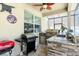Covered outdoor kitchen area with granite counters, ceiling fan, and multiple grills at 1043 Tourmaline Dr, Kissimmee, FL 34746