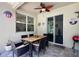 Cozy covered patio featuring an outdoor dining area with seating, a ceiling fan, and sliding glass doors at 1043 Tourmaline Dr, Kissimmee, FL 34746