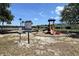 Community playground featuring climbing structure, slide, and safety guidelines for residents at 1043 Tourmaline Dr, Kissimmee, FL 34746