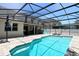 A refreshing private screened-in swimming pool with brick-paved patio and lounge chairs for relaxation at 1043 Tourmaline Dr, Kissimmee, FL 34746