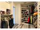 Large walk-in closet with custom shelving and storage solutions to neatly organize clothes and shoes at 1043 Tourmaline Dr, Kissimmee, FL 34746