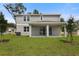Backyard with a covered patio and sliding glass doors leading indoors at 1051 Cloud Ridge Ct, Mount Dora, FL 32757