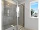 Bathroom shower showcasing modern tile work, glass door and a window at 1051 Cloud Ridge Ct, Mount Dora, FL 32757