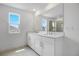 Bathroom featuring a double sink vanity, large mirror, and great natural light at 1051 Cloud Ridge Ct, Mount Dora, FL 32757