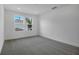 Bright bedroom with a large window, neutral walls, and plush carpeting at 1051 Cloud Ridge Ct, Mount Dora, FL 32757