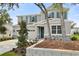 Inviting two-story home with stone accents, lush landscaping, and a two-car garage offering classic curb appeal at 1051 Cloud Ridge Ct, Mount Dora, FL 32757