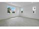 Bright living room with tile floors, recessed lighting, and large windows offering natural light at 1051 Cloud Ridge Ct, Mount Dora, FL 32757