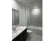 Well-appointed bathroom features a modern vanity, sleek fixtures, and tiled shower/tub combo, creating a spa-like experience at 1053 Waterfall Blvd, Davenport, FL 33837