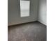 Cozy bedroom featuring a window with blinds and plush gray carpeting at 1053 Waterfall Blvd, Davenport, FL 33837