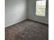Comfortable bedroom featuring fresh paint, plush carpeting, and a bright window, providing a cozy and inviting atmosphere at 1053 Waterfall Blvd, Davenport, FL 33837