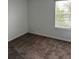 Bright bedroom featuring a window with blinds and plush gray carpeting at 1053 Waterfall Blvd, Davenport, FL 33837