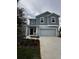 Beautiful two-story home with modern architecture and a well-manicured front yard at 1053 Waterfall Blvd, Davenport, FL 33837
