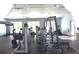 Well-equipped fitness center with modern exercise machines, weights, and a TRX system, promoting a healthy and active lifestyle at 1053 Waterfall Blvd, Davenport, FL 33837